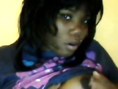 Ebony cam girl sucking her breasts